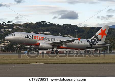 Stock Image - Airbus A320 of Jetstar taking off from Wellington Airport. Fotosearch
