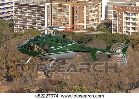 Bell 407 helicopter over Johannesburg, South Africa View Large Photo Image Picture - Bell 407 helicopter over Johannesburg, South Africa. Fotosearch