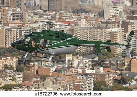 Stock Photograph - Bell 407 helicopter over Johannesburg, South Africa. Fotosearch