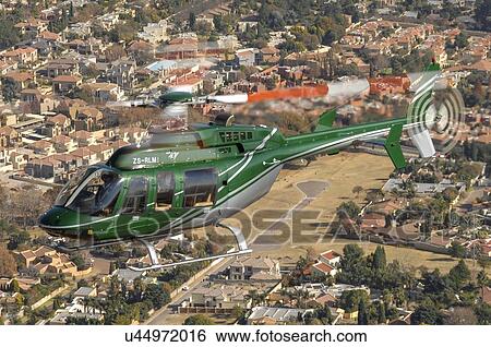 Stock Photograph - Bell 407 helicopter over Johannesburg. Fotosearch