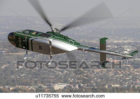Stock Photography - Bell 407 helicopter over Johannesburg, South Africa. Fotosearch