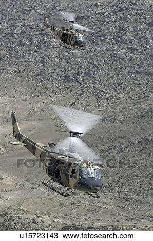Stock Image - Bell Huey II in flight near Kabul. Fotosearch