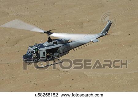 Stock Image - Bell Huey II in flight over the Registan Desert, Afghanistan. Fotosearch