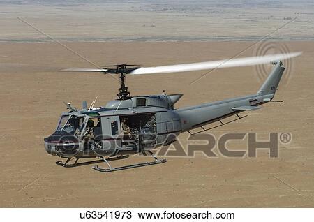 Stock Image - Bell Huey II in flight over the Registan Desert, Afghanistan. Fotosearch