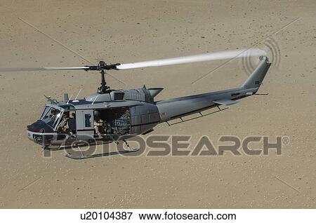 Stock Photo - Bell Huey II in flight over the Registan Desert. Fotosearch
