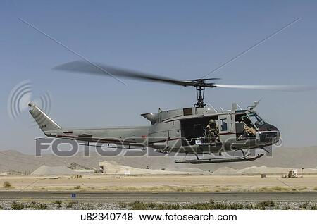 Stock Photo - Bell Huey II landing at Kandahar Airfield. Fotosearch