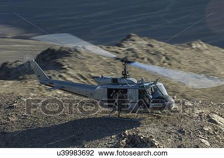 Stock Image - Bell Huey II on a mountain top near Kandahar, Afghanistan. Fotosearch