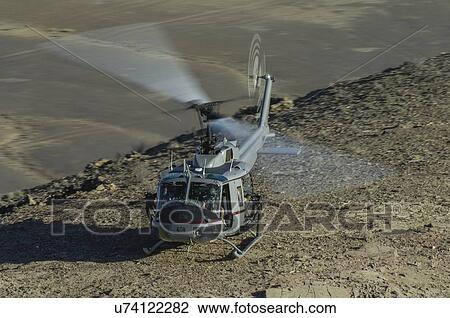 Stock Image - Bell Huey II on a mountain top near Kandahar, Afghanistan. Fotosearch