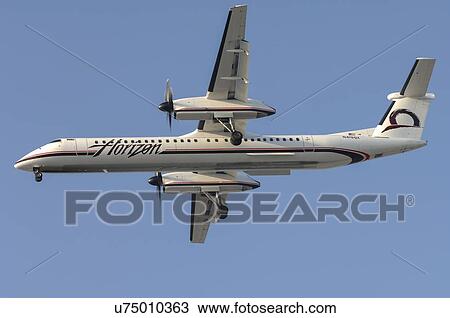Stock Image - Bombardier Q400 of Horizon Airline landing at Los Angeles International Airport. Fotosearch