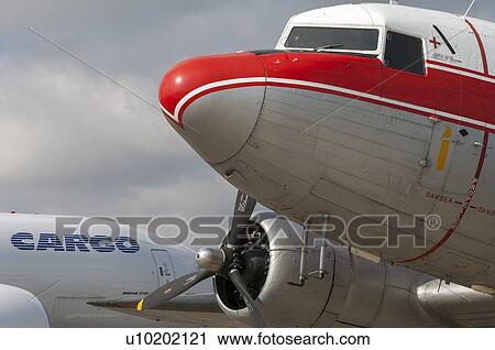 Close up of DC-3 nose with Boeing 777 Freighter in background View Large Photo Image Stock Image - Close up of DC-3 nose with Boeing 777 Freighter in background. Fotosearch