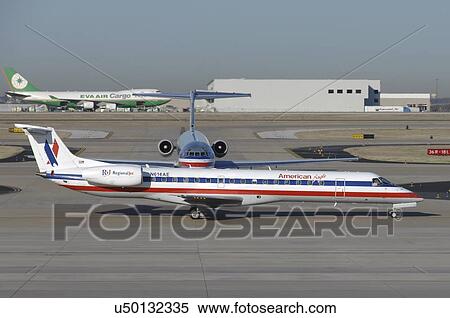 Stock Photography - Embraer 145 of American Eagle taxies at Dallas Airport. Fotosearch