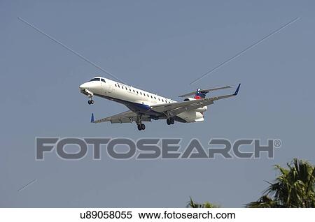 Stock Photography - Embraer 145XR on final approach to Los Angeles International Airport. Fotosearch