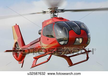 Stock Image - Eurocopter EC130B4 helicopter landing at Moorabbin Airport, Melbourne, Australia. Fotosearch
