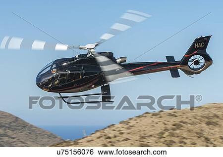 Eurocopter EC130B4 in flight over farmland near Wellington View Large Photo Image Stock Photograph - Eurocopter EC130B4 in flight over farmland near Wellington. Fotosearch
