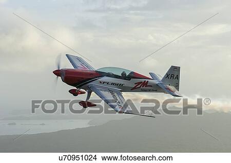 Picture - Extra Aircraft Extra 300 in flight over the Hauraki Gulf. Fotosearch