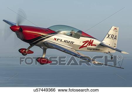 Stock Photograph - Extra Aircraft Extra 300 in flight over Auckland Harbour. Fotosearch