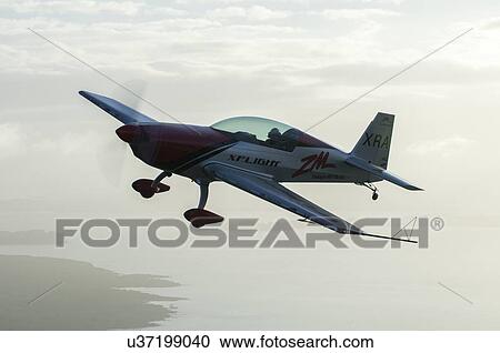 Stock Image - Extra Aircraft Extra 300 in flight. Fotosearch