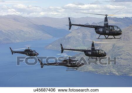 Helicopter formation over Lake Wakatipu near Queenstown, New Zealand. Two Robinson R44s and two Eurocopter AS350s View Large Photo Image Stock Photograph - Helicopter formation over Lake Wakatipu near Queenstown, New Zealand. Two Robinson R44s and two Eurocopter AS350s. Fotosearch