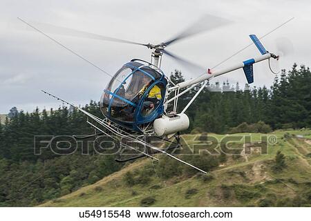 Helicopters in flight conducting aerial spraying View Large Photo Image Stock Photo - Helicopters in flight conducting aerial spraying. Fotosearch