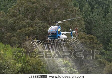 Stock Photography - Helicopters in flight conducting aerial spraying. Fotosearch