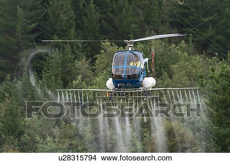 Hughes 269C in flight conducting aerial spraying View Large Photo Image Picture - Hughes 269C in flight conducting aerial spraying. Fotosearch
