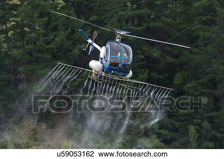 Hughes 269C in flight conducting aerial spraying View Large Photo Image Stock Image - Hughes 269C in flight conducting aerial spraying. Fotosearch