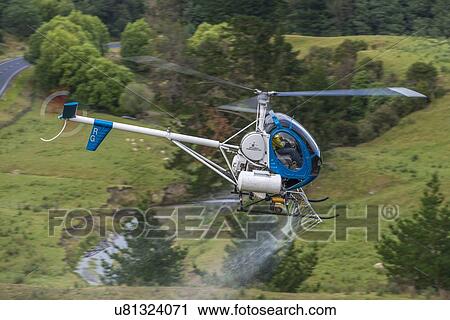 Hughes 269C in flight conducting aerial spraying View Large Photo Image Stock Image - Hughes 269C in flight conducting aerial spraying. Fotosearch