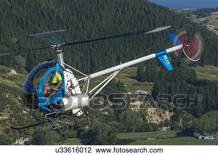 Stock Image - Hughes 269C in flight. Fotosearch