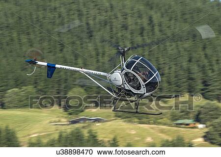 Stock Image - Hughes 269C in flight. Fotosearch