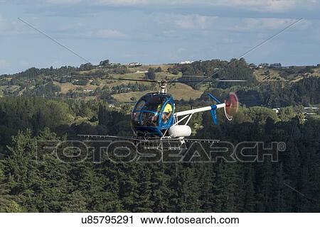 Stock Image - Hughes 269C in flight. Fotosearch