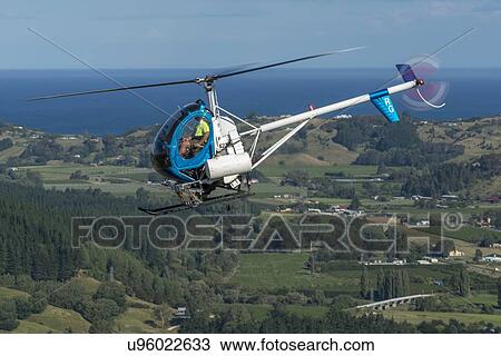 Stock Image - Hughes 269C in flight. Fotosearch