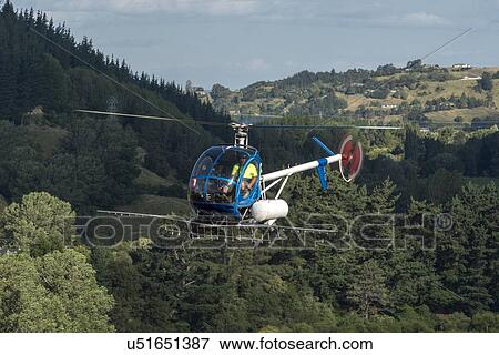 Stock Photo - Hughes 269C in flight. Fotosearch
