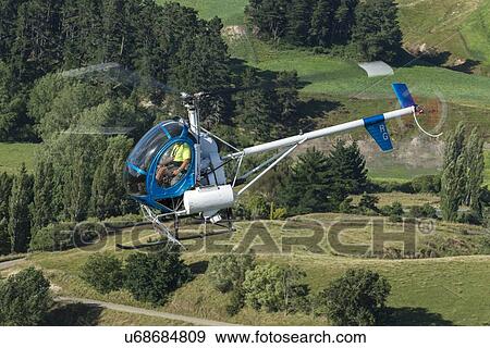 Stock Photo - Hughes 269C in flight. Fotosearch