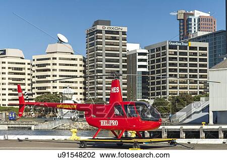 Stock Image - Robinson R44 helicopter at Queens Wharf heliport. Fotosearch