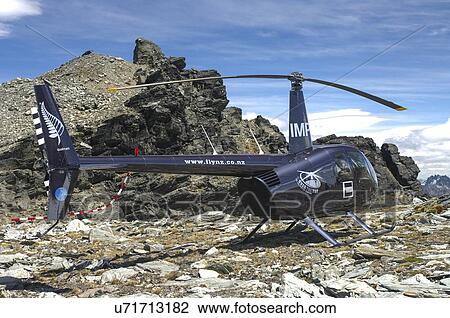 Robinspon R44 helicopter landed on a mountain top View Large Photo Image Stock Image - Robinspon R44 helicopter landed on a mountain top. Fotosearch