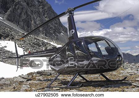 Robinspon R44 helicopter landed on a mountain top near Queenstown View Large Photo Image Stock Photography - Robinspon R44 helicopter landed on a mountain top near Queenstown. Fotosearch