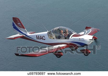 SportStar light aircraft in flight over water View Large Photo Image Stock Photo - SportStar light aircraft in flight over water. Fotosearch