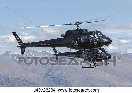 Two Eurocopter AS350 helicopters in formation View Large Photo Image Picture - Two Eurocopter AS350 helicopters in formation . Fotosearch