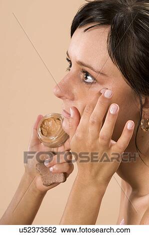 Stock Image - Applying make-up. Fotosearch