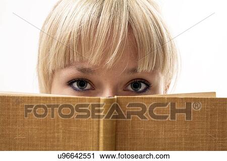 Stock Image - Blonde woman reading a book. Fotosearch