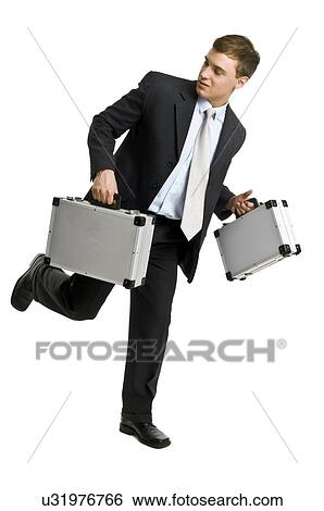 Business man carrying briefcases View Large Photo Image Stock Photograph - Business man carrying briefcases. Fotosearch