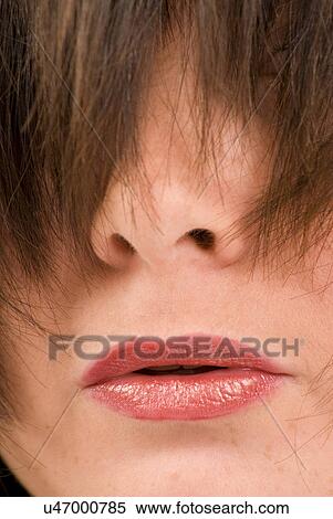 Close-up of women's face with hair over eyes View Large Photo Image Stock Photography - Close-up of women's face with hair over eyes. Fotosearch