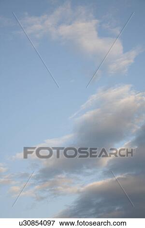 Stock Photo - Clouds in a blue sky. Fotosearch