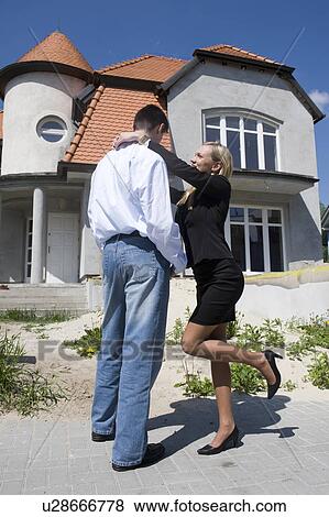 Stock Photo - Couple outside house. Fotosearch