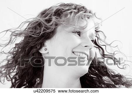 Stock Photography - Happy young women with long curly hair. Fotosearch