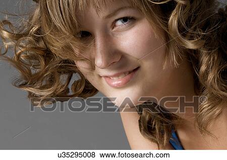 Stock Photo - Headshot of young women with curly hair. Fotosearch