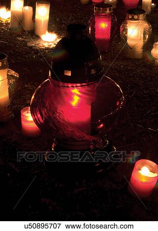Stock Photo - Lit candles in the dark. Fotosearch