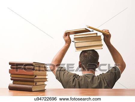 Stock Photograph - Man balancing books on his head. Fotosearch