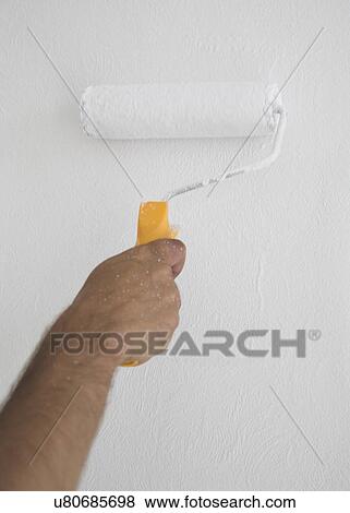 Stock Photo - Man painting the wall. Fotosearch