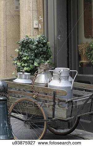 Milk jugs on a wooden cart View Large Photo Image Stock Photo - Milk jugs on a wooden cart. Fotosearch